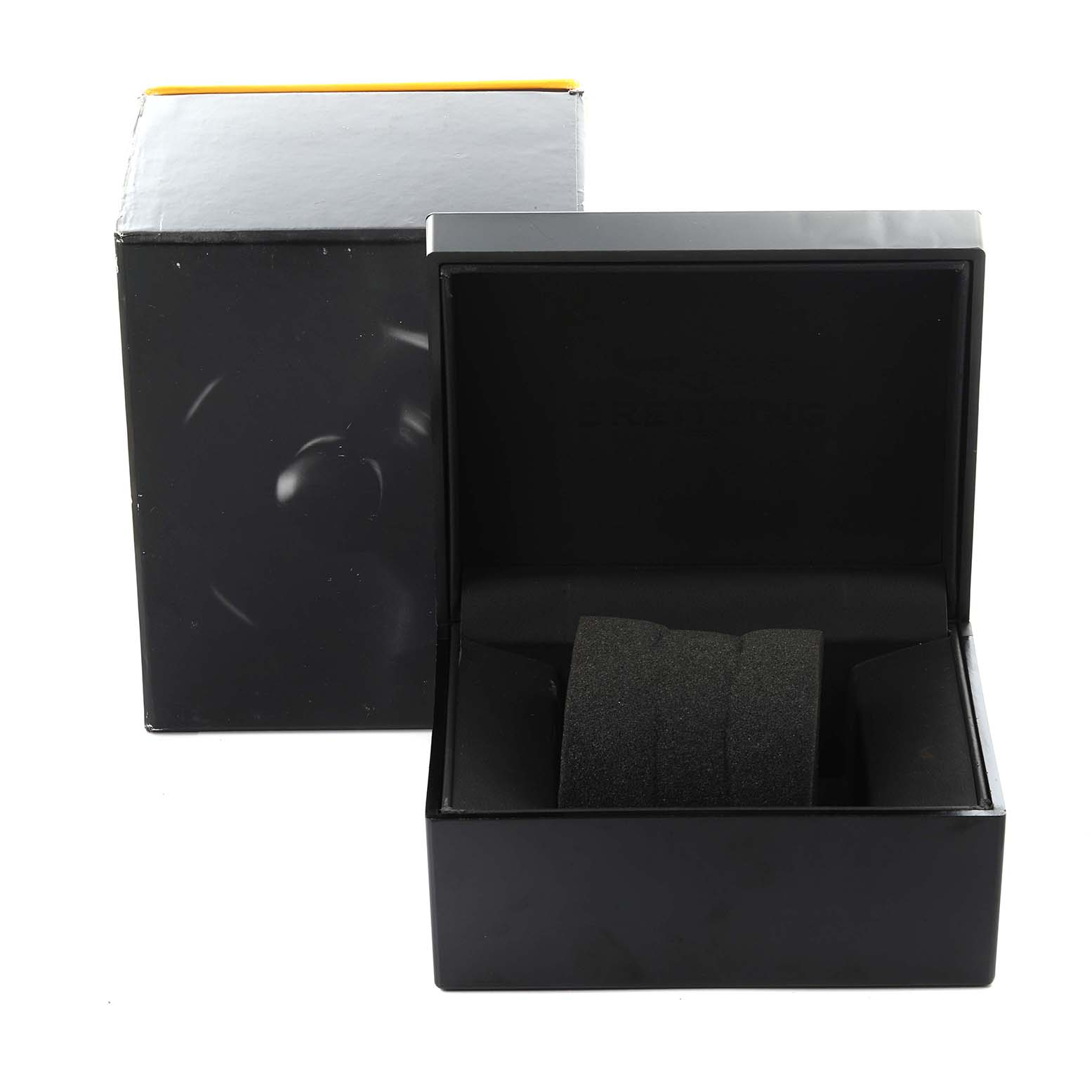The image shows a black Bentley by Breitling watch box and a gray cushion inside.