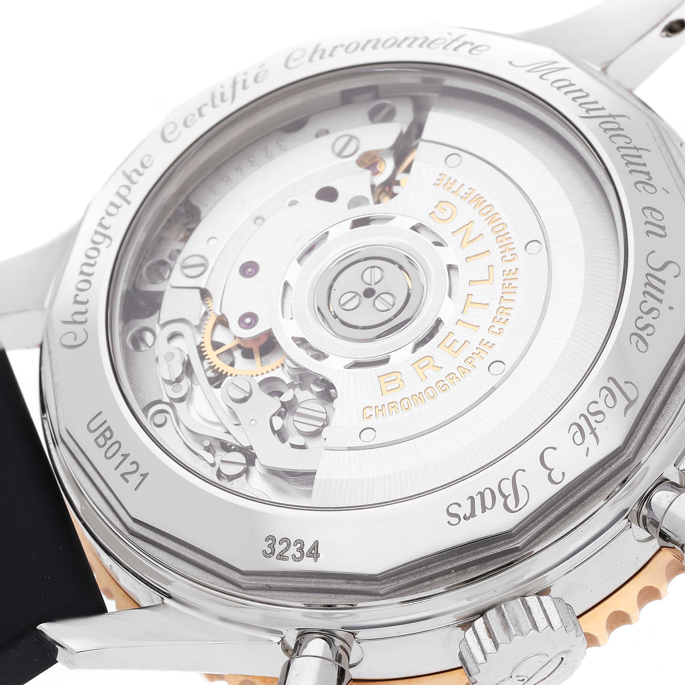 The image shows the case back and movement of a Breitling Navitimer UB012111 Men's Steel and Gold (two tone) Grey Dial UB012111 Men's Steel and Gold (two tone) Grey Dial watch at an angle that highlights its inner workings.