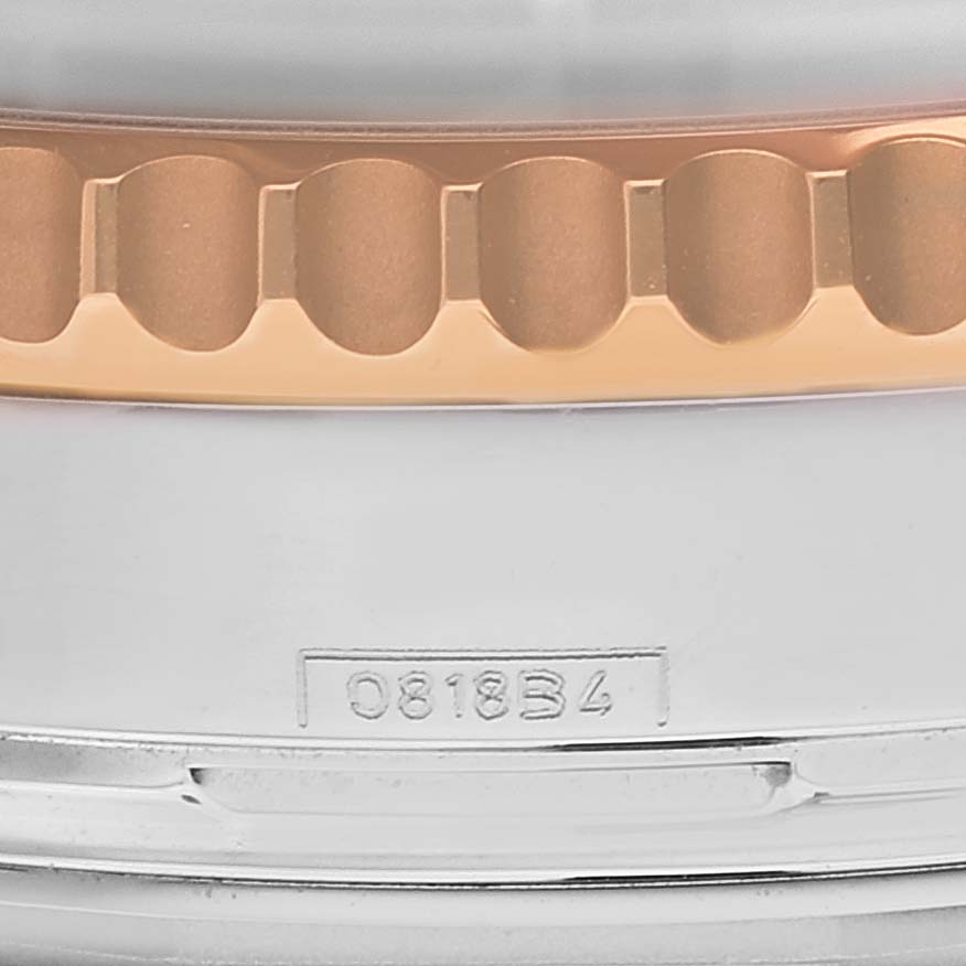 The image shows a close-up of the bezel and case with a serial number of a Breitling Navitimer UB012111 Men's Steel and Gold (two tone) Grey Dial UB012111 Men's Steel and Gold (two tone) Grey Dial watch.