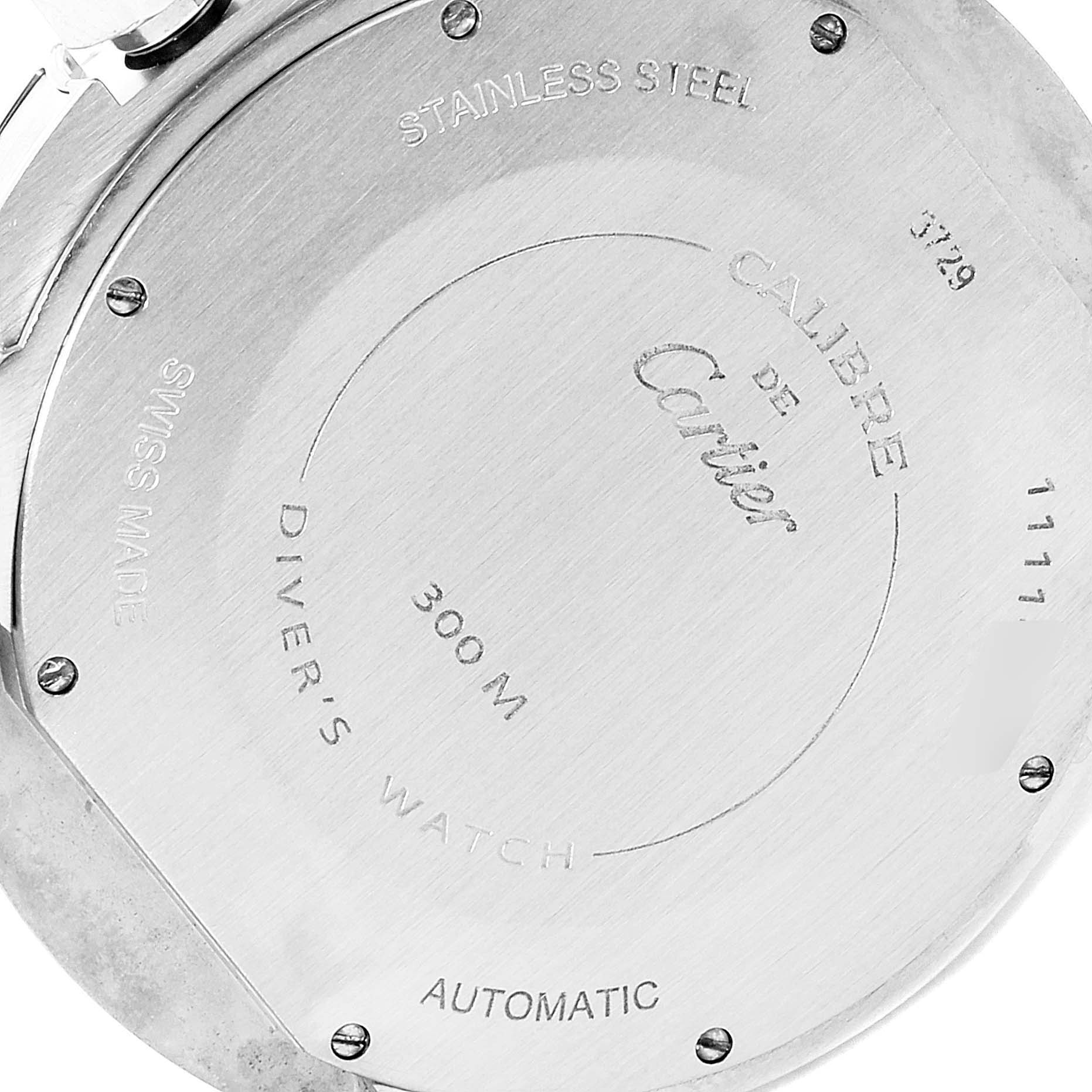 The image shows the stainless steel back case of the Calibre de Cartier model by Cartier.