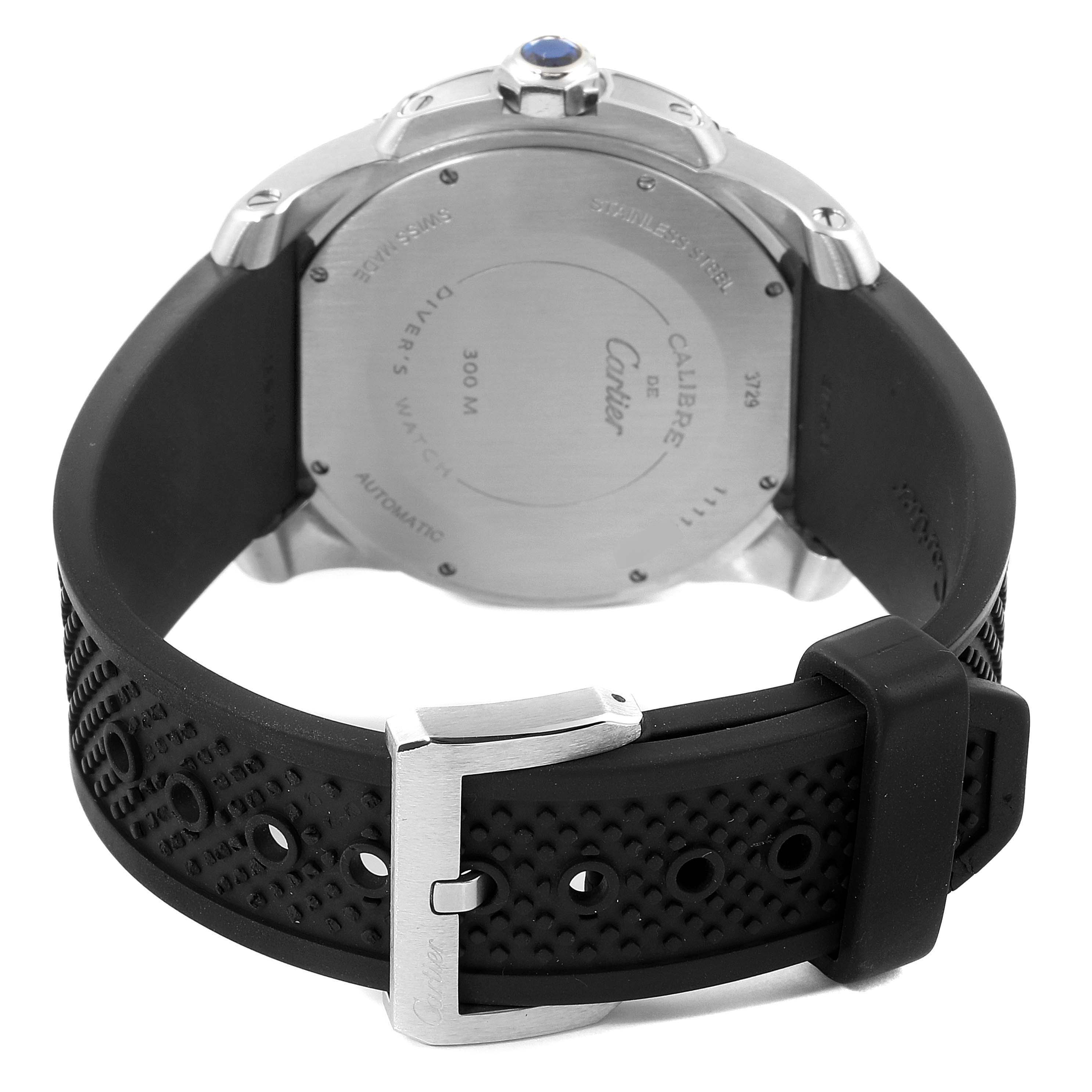 This image shows the back of a Calibre de Cartier watch and its black textured strap with a metal buckle.