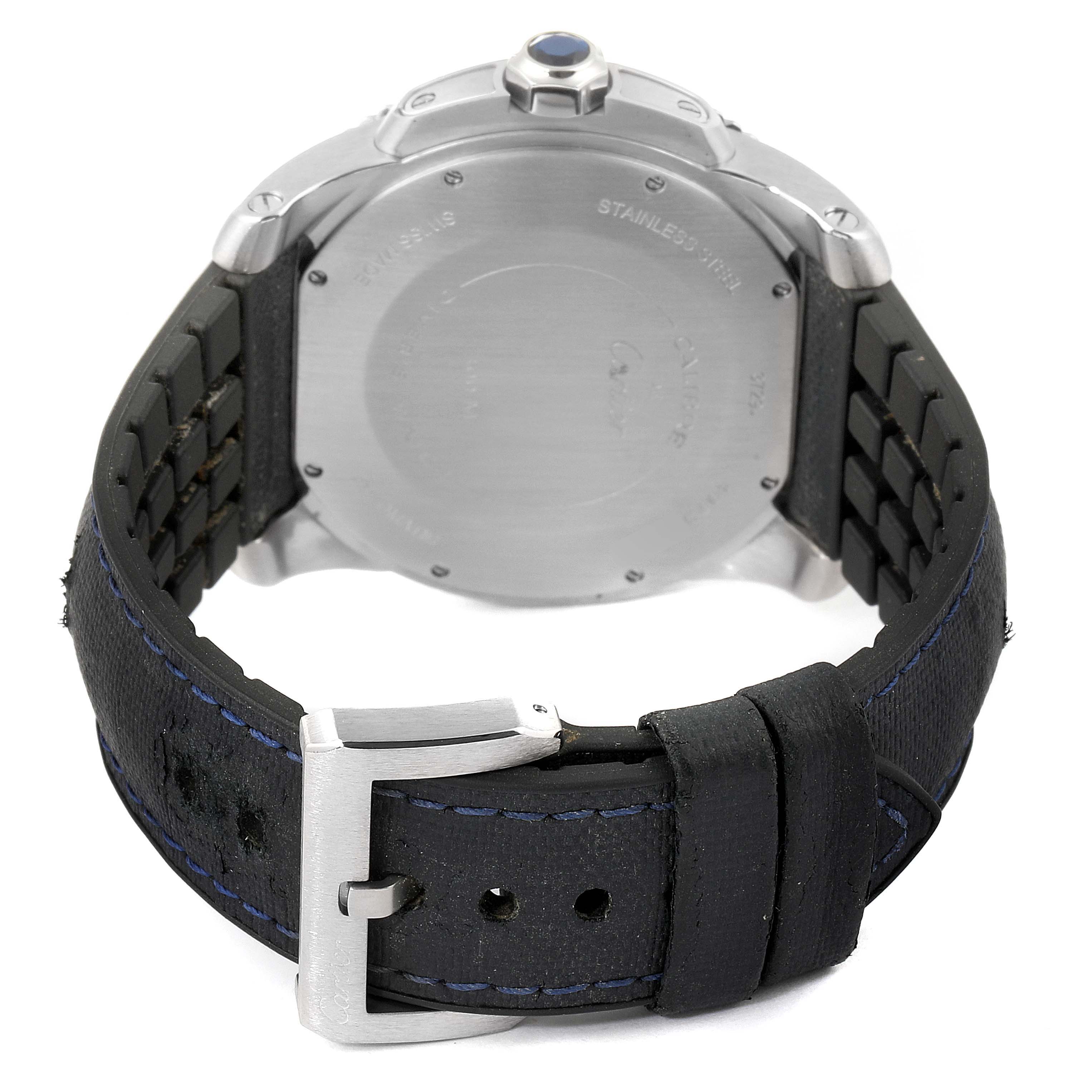 The image shows the back of a Calibre de Cartier watch by Cartier, focusing on the case back, strap, and buckle.