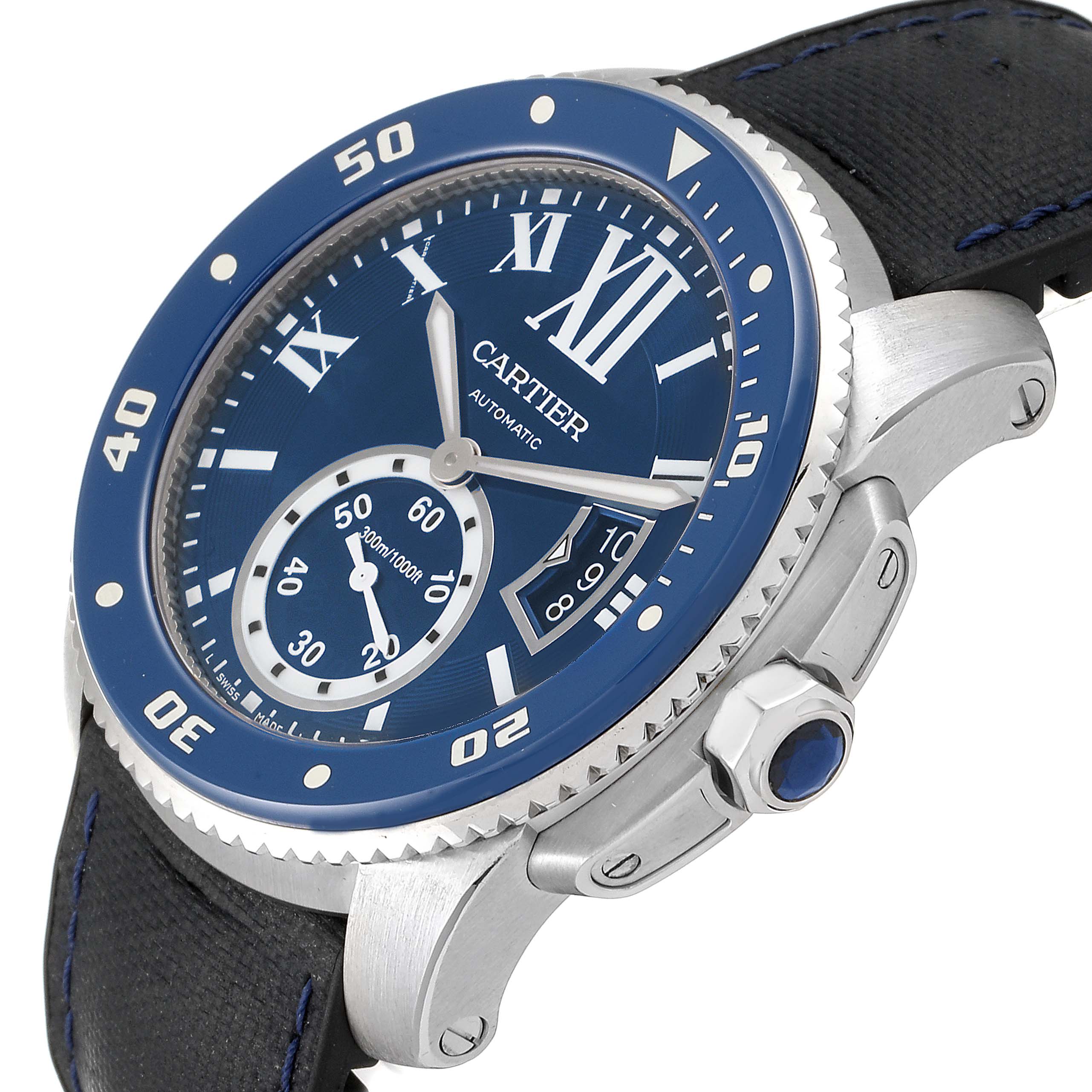 The image shows a Calibre de Cartier watch by Cartier at an angled view, highlighting the blue dial, bezel, and crown.
