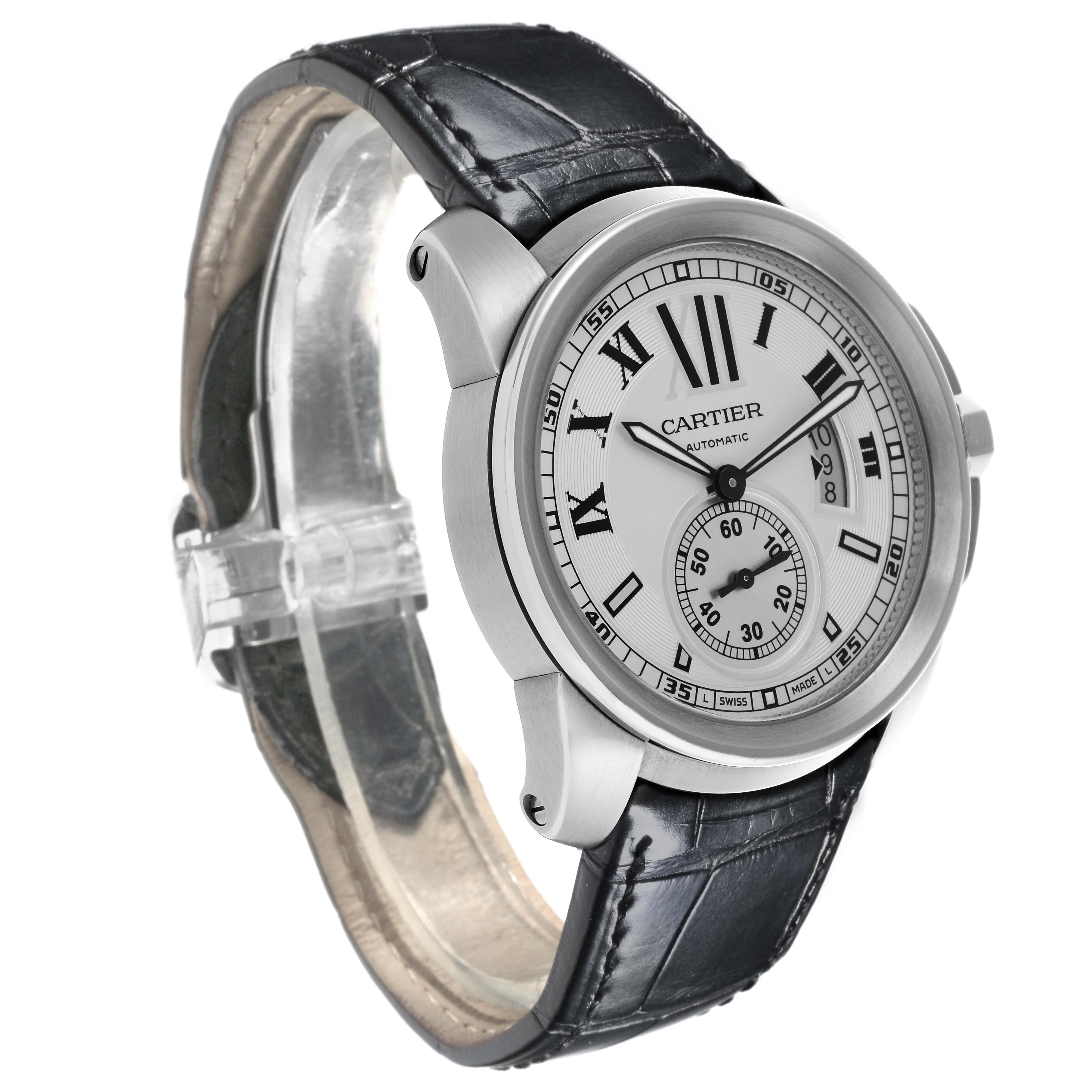 The Calibre de Cartier watch is shown at a three-quarter angle, highlighting the face, bezel, and leather strap.