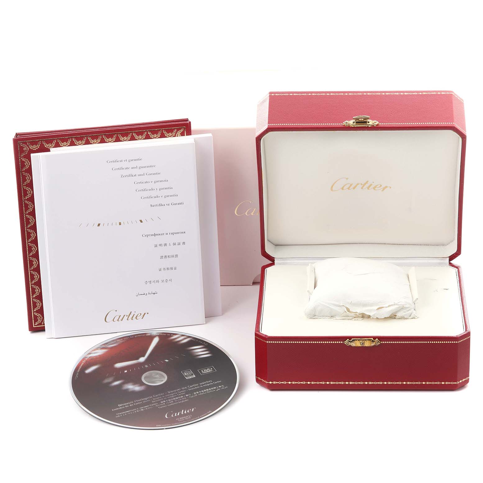 The image shows an open Cartier box, warranty documents, and a CD for the Calibre de Cartier watch.