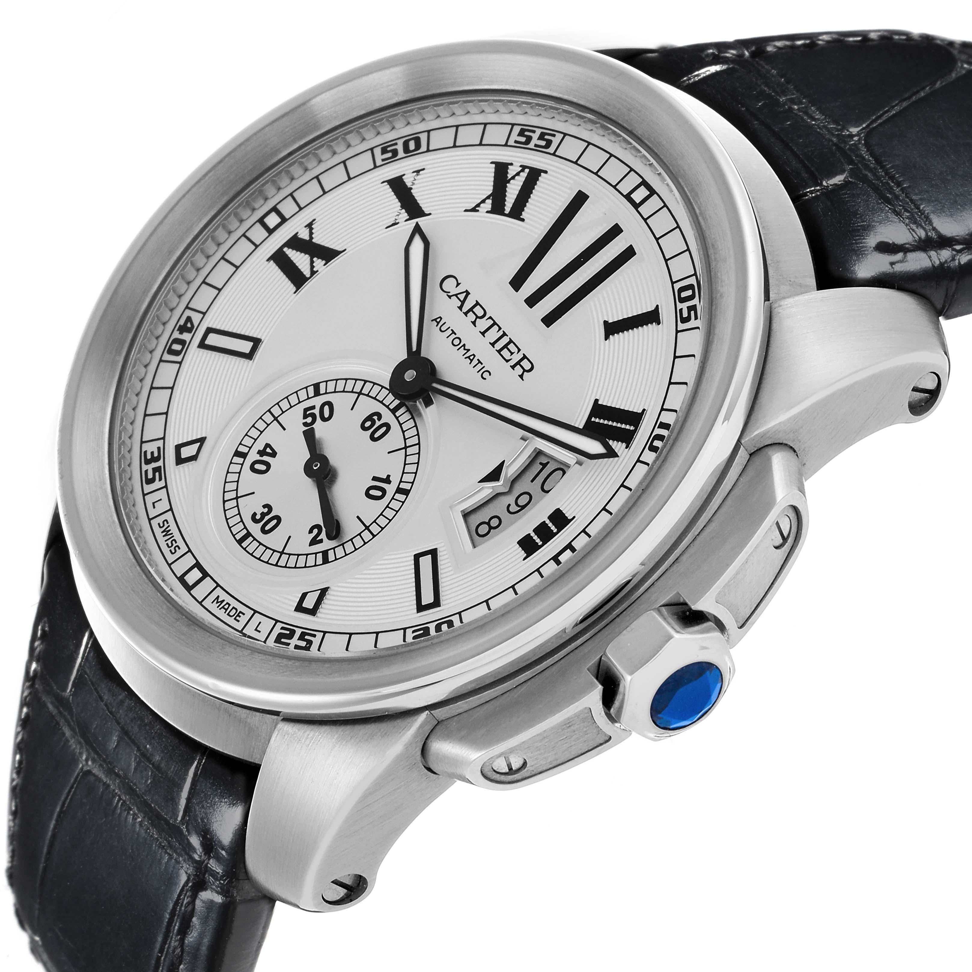 The Calibre de Cartier watch is shown at a slight angle, highlighting the dial, side crown, and leather strap.