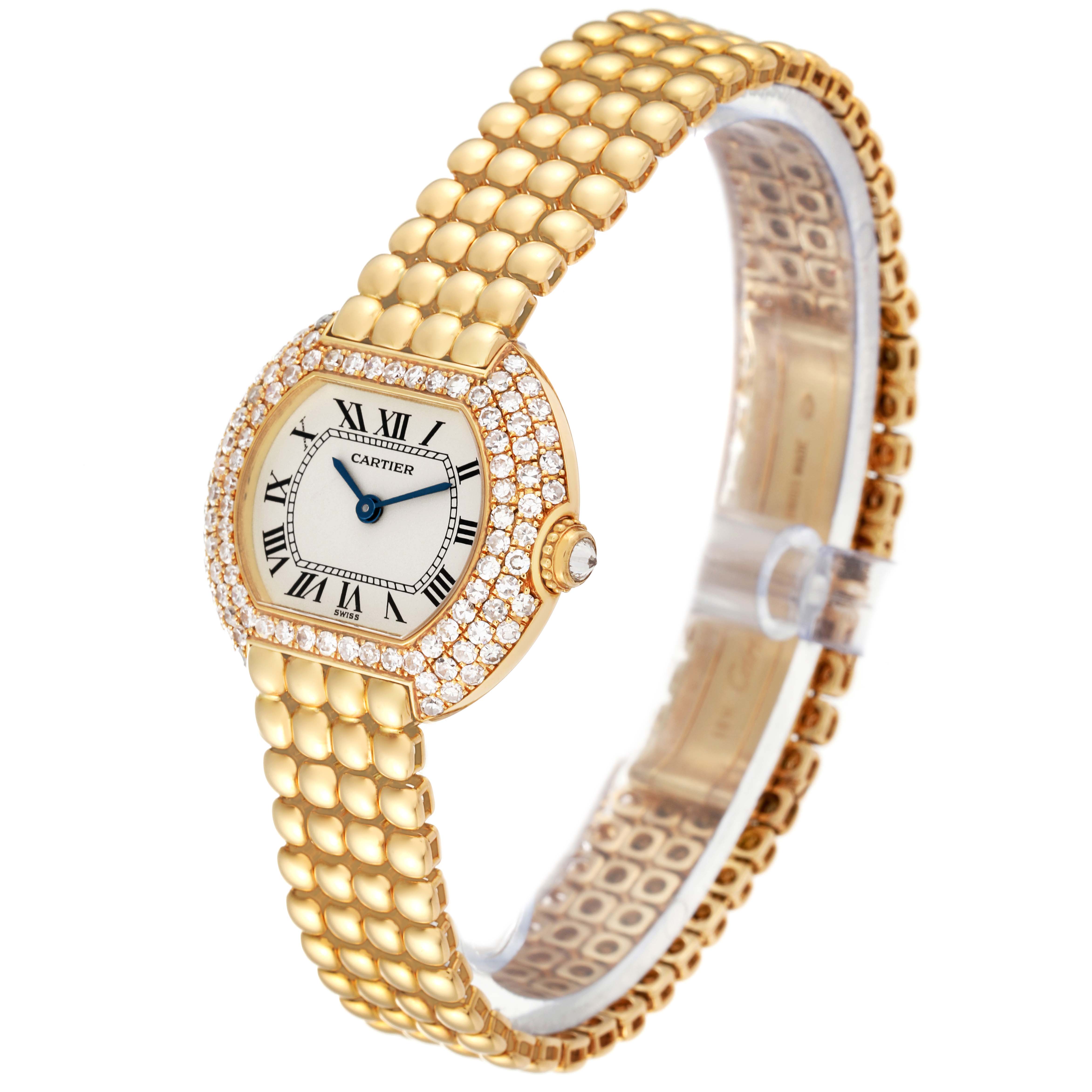 The Cartier Tortue Women's Yellow Gold Silver Dial Women's Yellow Gold Silver Dial watch is shown at a slight angle, displaying its face, strap, and diamond-encrusted bezel.