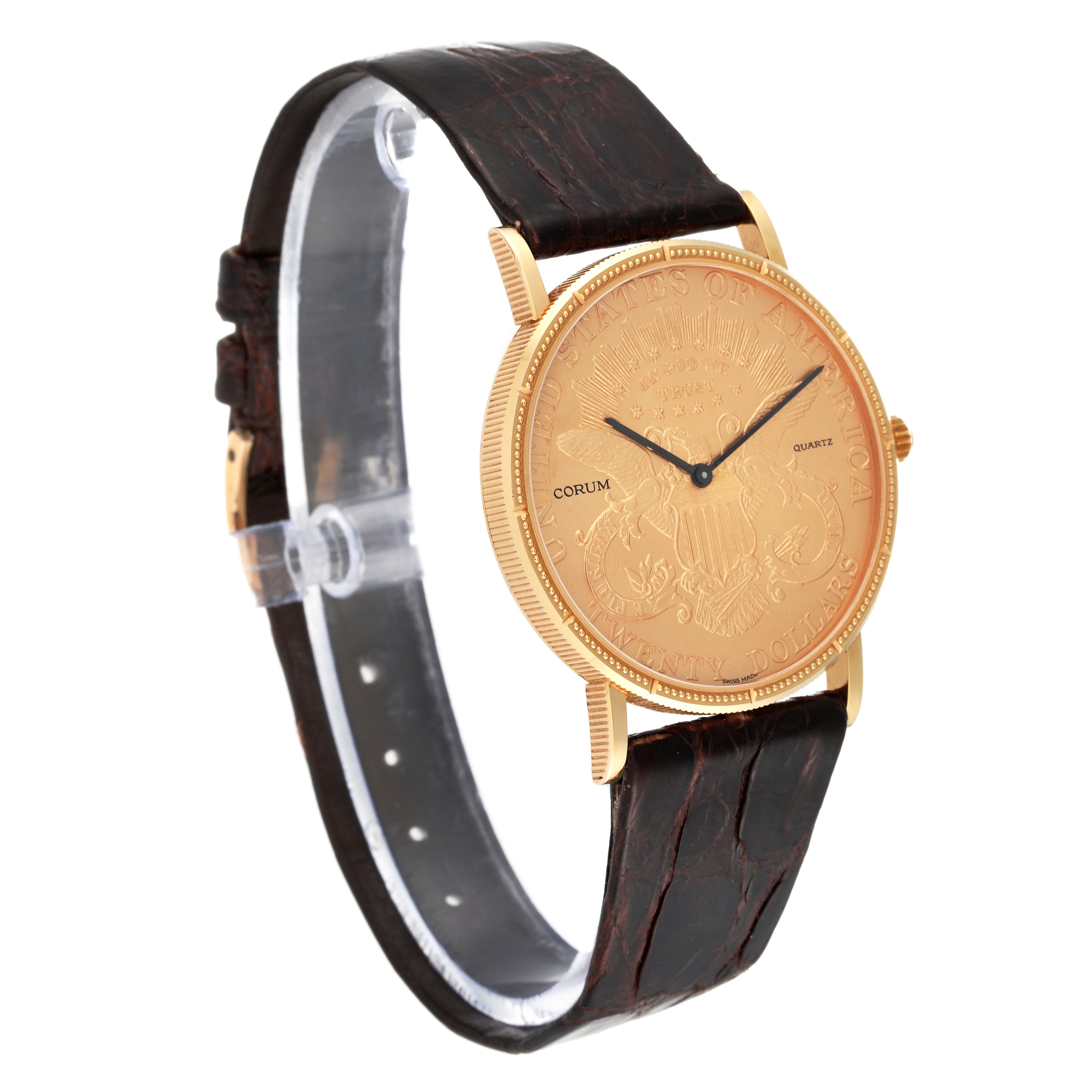 The image shows a Corum Coin Watch 4414556 Men's Yellow Gold Champagne Dial 4414556 Men's Yellow Gold Champagne Dial model angled to display the embossed dial, leather strap, and crown.