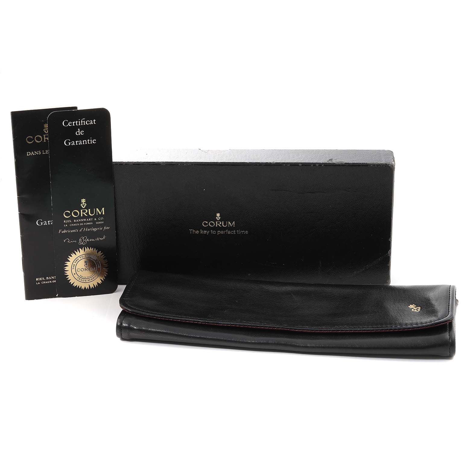 The image shows the box, certificate of guarantee, and carrying case for the Corum Coin Watch 4414556 Men's Yellow Gold Champagne Dial 4414556 Men's Yellow Gold Champagne Dial model.