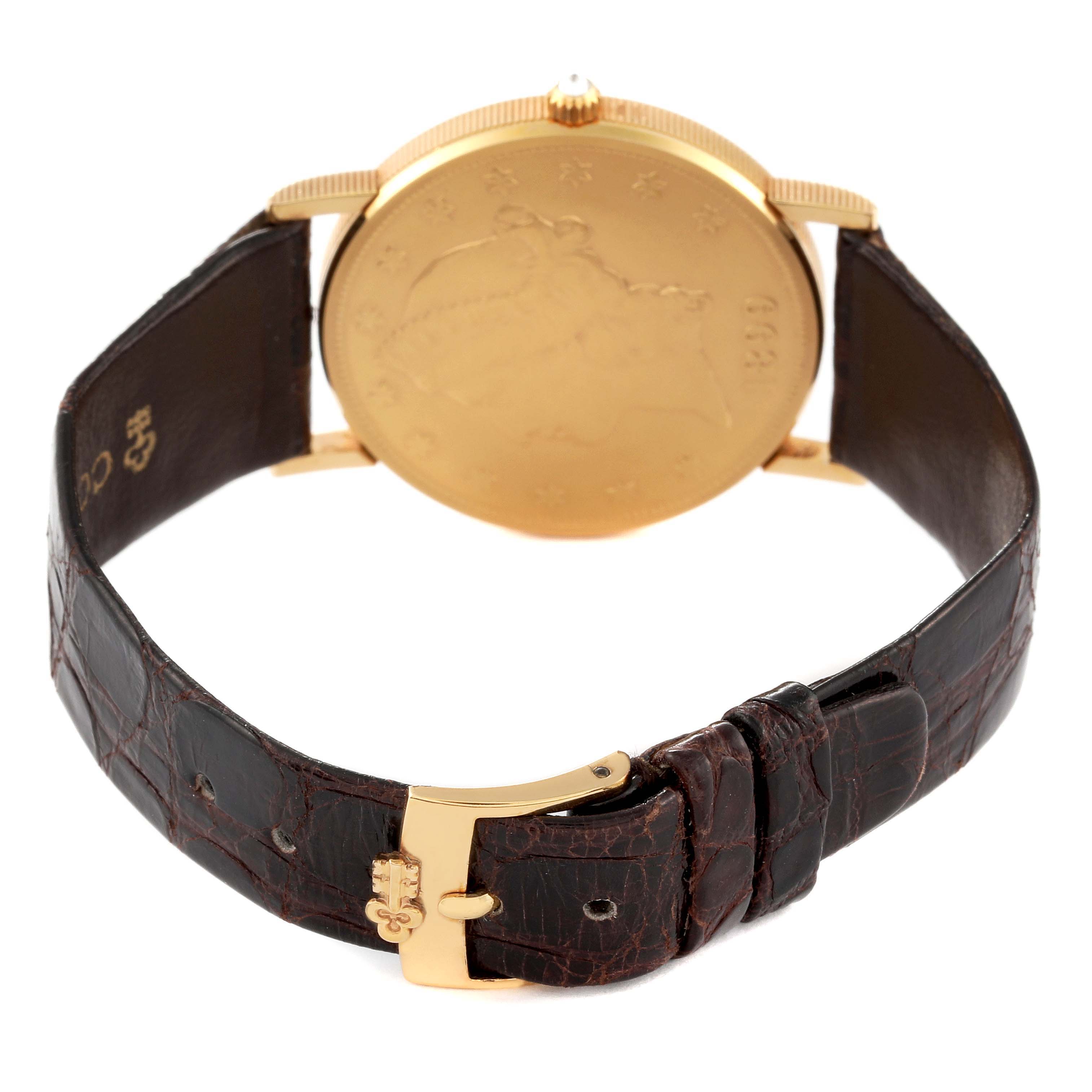 The image shows the back view of a Corum Coin Watch 4414556 Men's Yellow Gold Champagne Dial 4414556 Men's Yellow Gold Champagne Dial model with a brown leather strap and gold buckle.