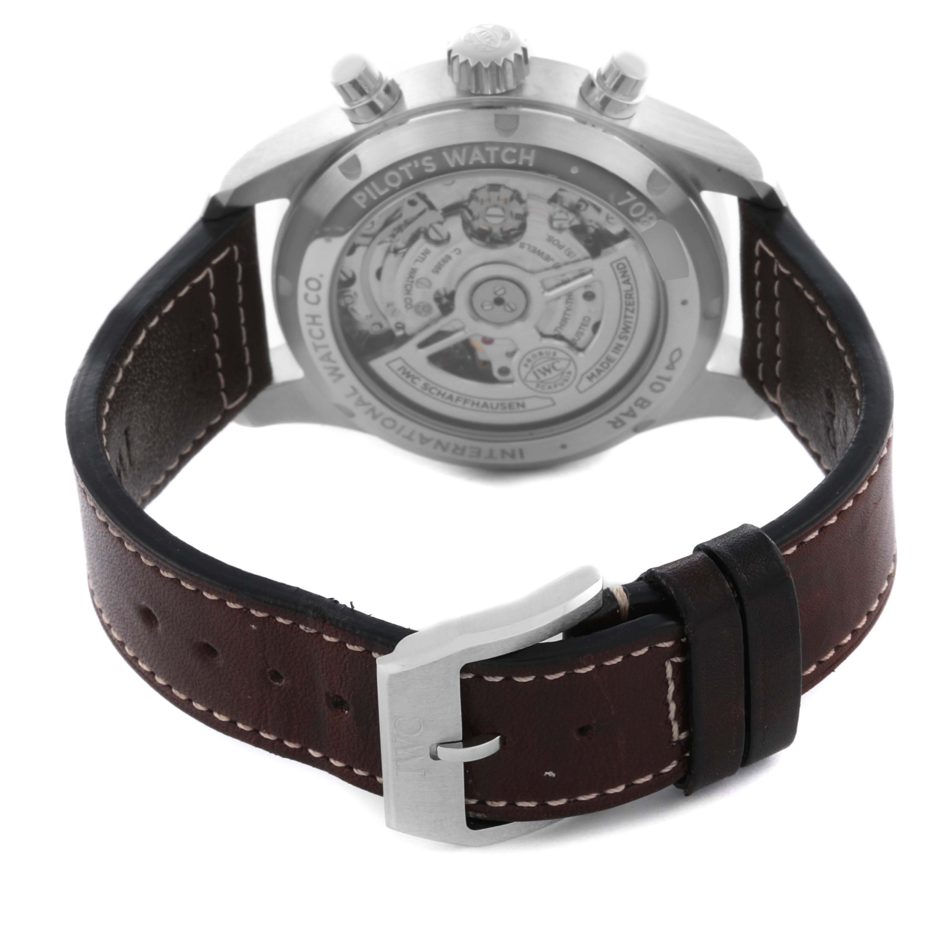 The image shows the back of an IWC Pilot IW388103 Men's Stainless Steel Green Dial IW388103 Men's Stainless Steel Green Dial model watch with an open case back and a brown leather strap.