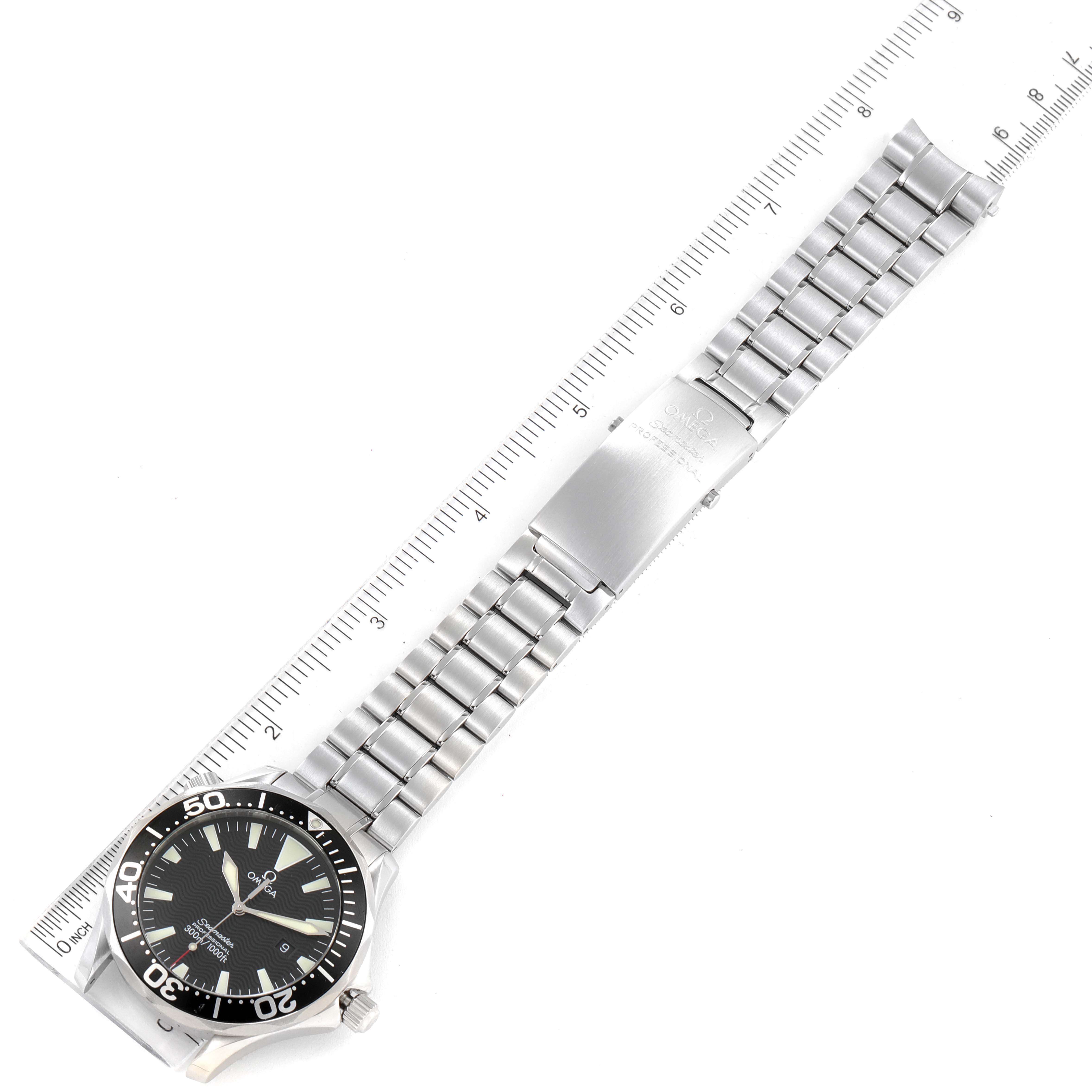 The Seamaster model watch by Omega is shown from a top-down angle, displaying the face, bezel, and metal bracelet.