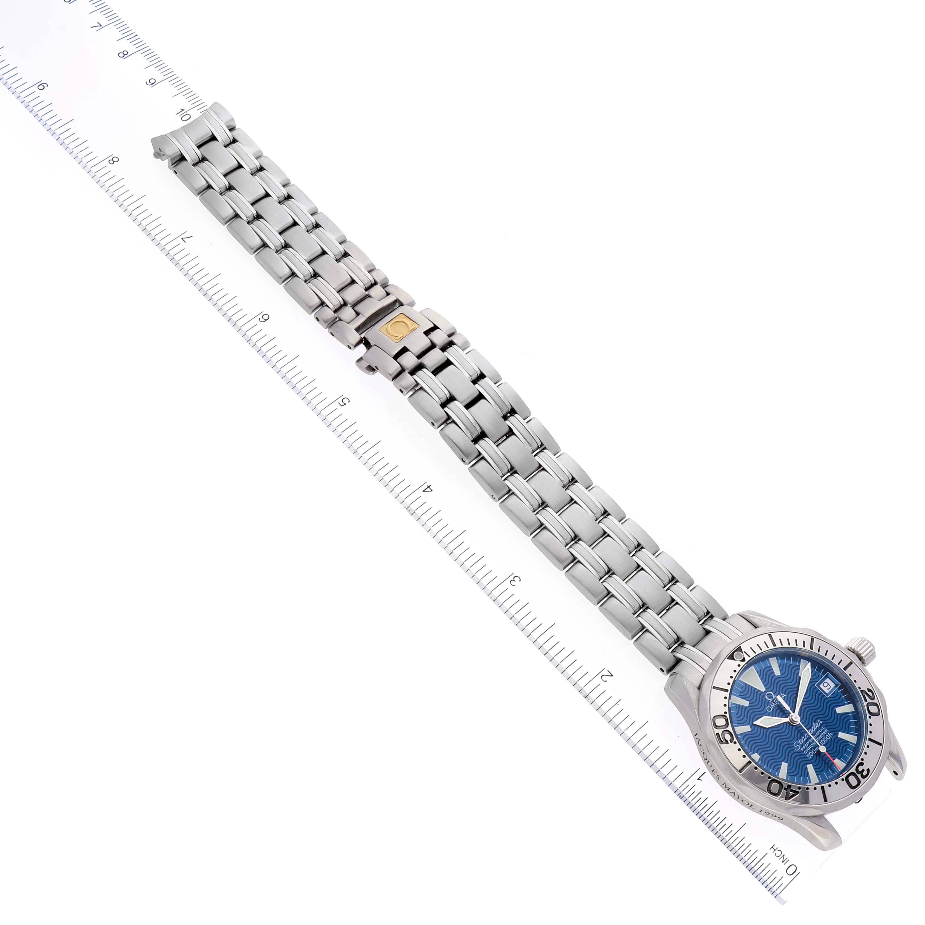 The image shows an Omega Seamaster 2554.80.00 Men's Stainless Steel Blue Dial 2554.80.00 Men's Stainless Steel Blue Dial watch from a top-down angle, displaying the face, bracelet, and clasp next to a ruler.