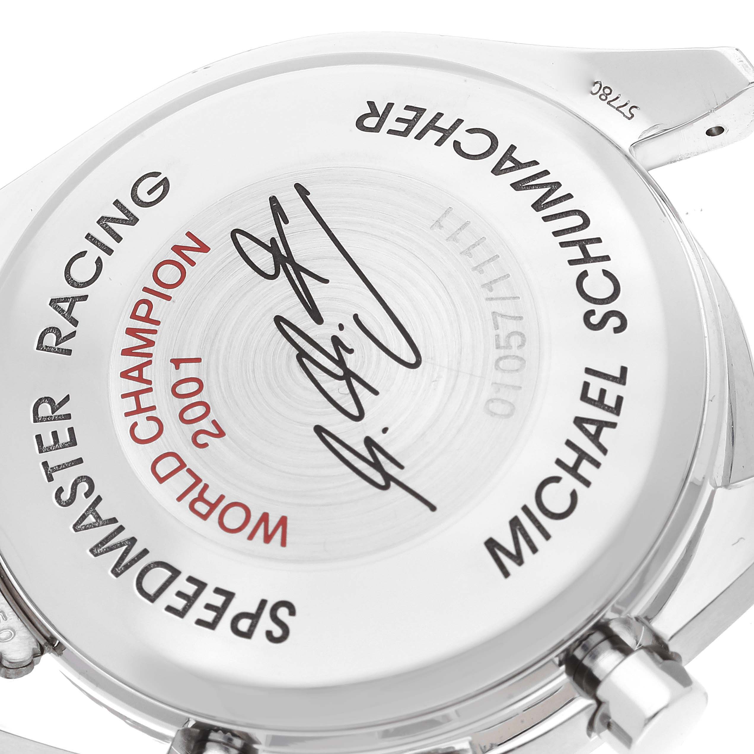 The image shows the back case of an Omega Speedmaster 3519.50.00 Men's Stainless Steel Black Dial 3519.50.00 Men's Stainless Steel Black Dial Racing watch, featuring an engraved dedication to Michael Schumacher.