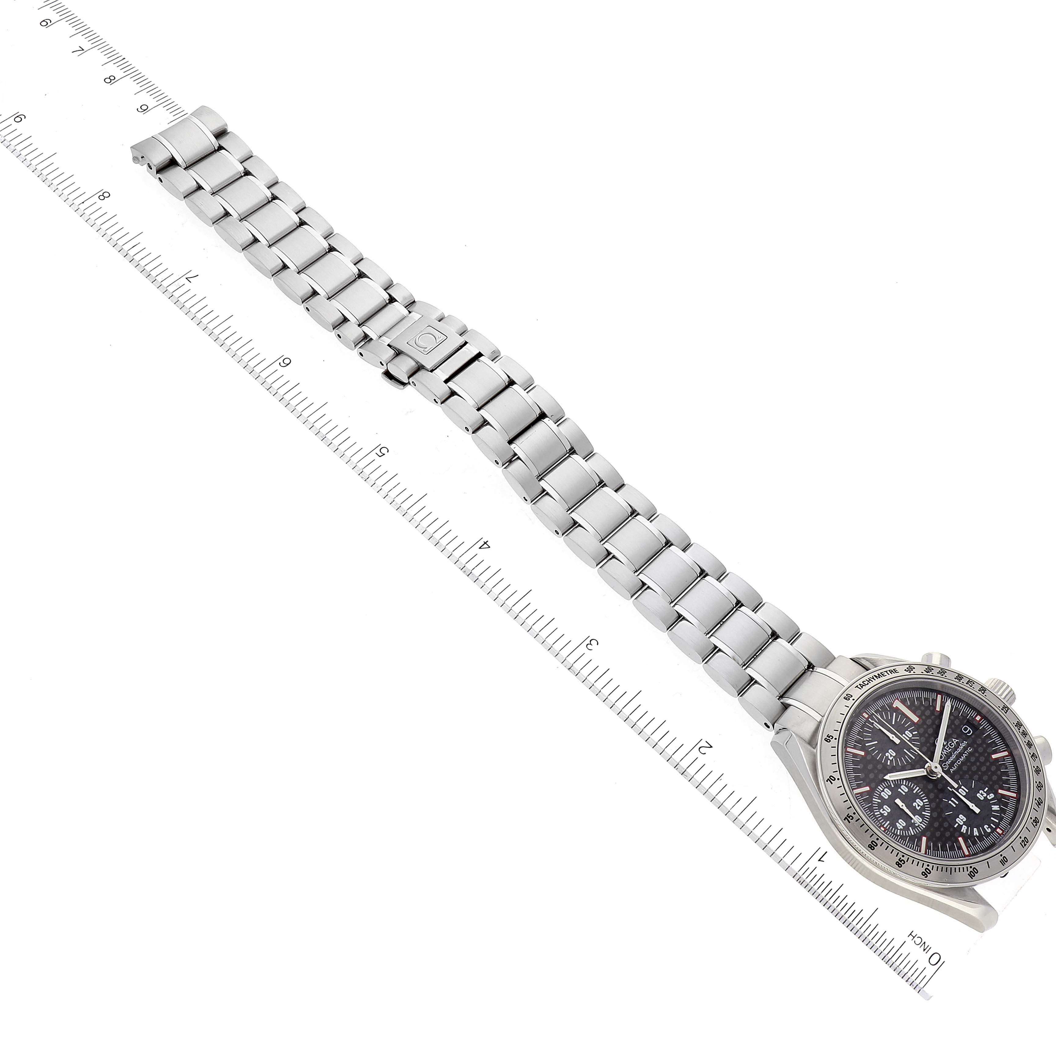 This image shows a full view of an Omega Speedmaster 3519.50.00 Men's Stainless Steel Black Dial 3519.50.00 Men's Stainless Steel Black Dial watch laid flat next to a ruler, highlighting the bracelet and case.