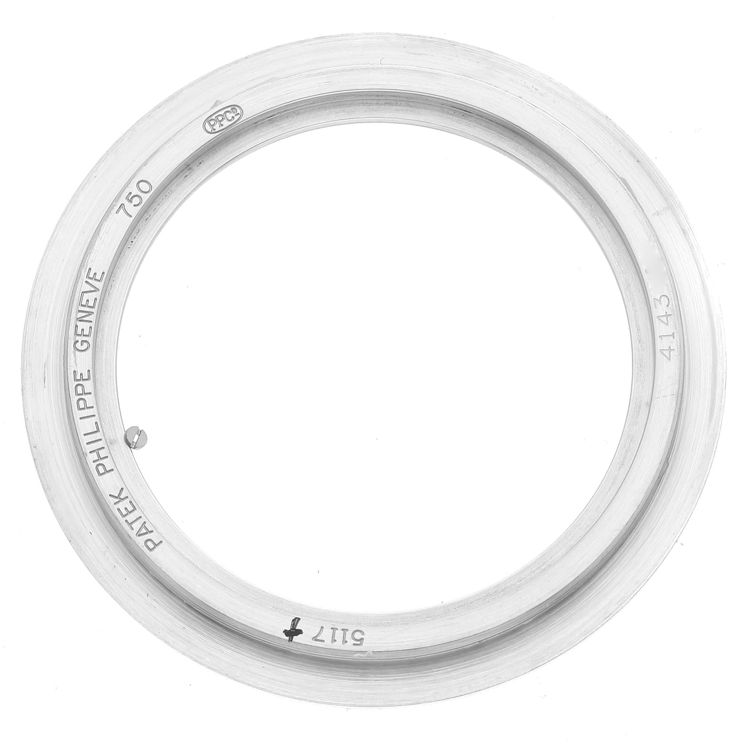 This image shows the bezel of a Patek Philippe Calatrava 5117G-001 Men's White Gold White Dial 5117G-001 Men's White Gold White Dial watch, featuring branding and model inscriptions.