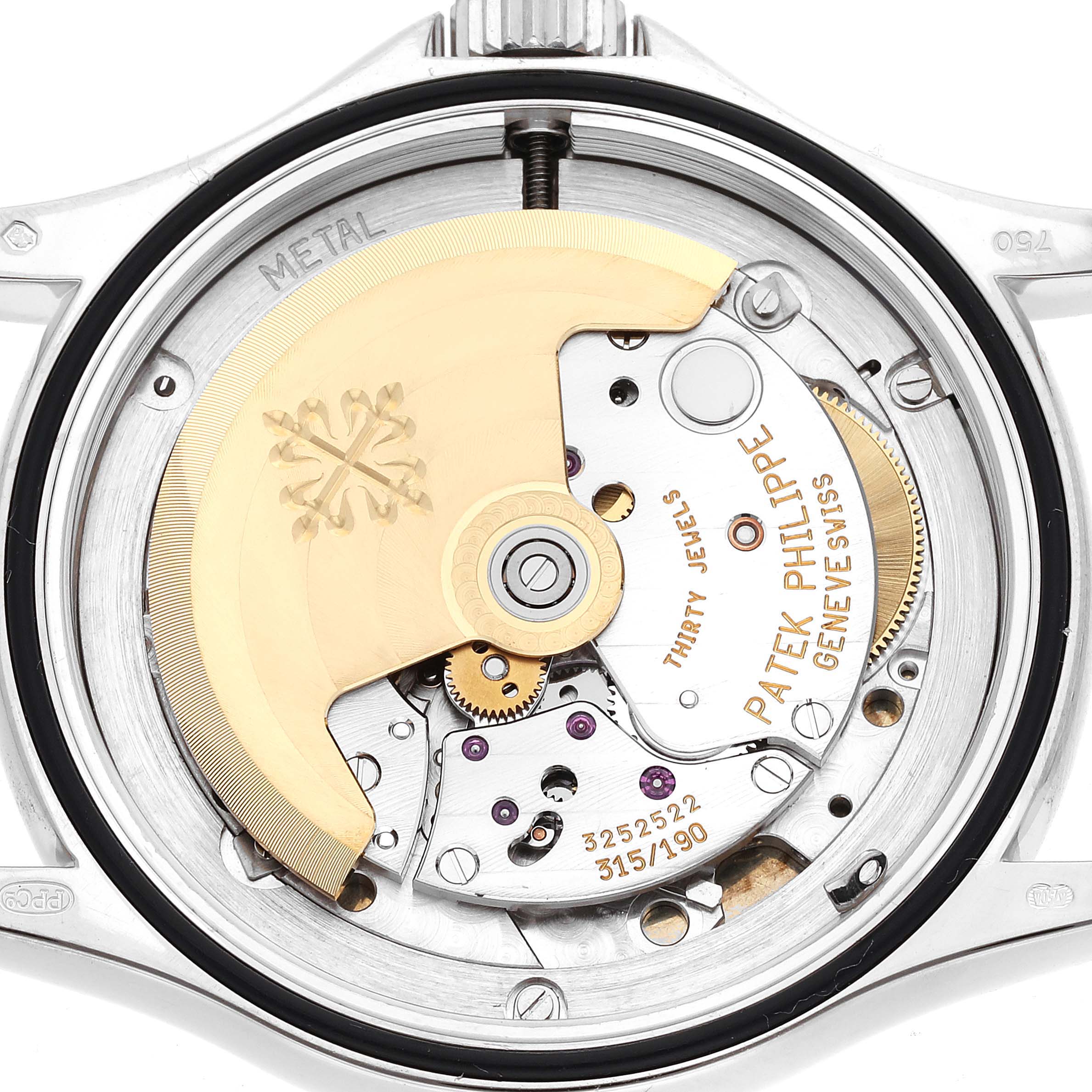 This image shows the backside of a Patek Philippe Calatrava 5117G-001 Men's White Gold White Dial 5117G-001 Men's White Gold White Dial watch, highlighting the intricate movement and engravings.