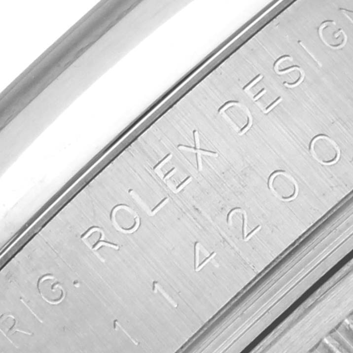 This close-up shows the engraved side of the Rolex Air-King 114200 Men's Stainless Steel Silver Dial 114200 Men's Stainless Steel Silver Dial's case with its model details.