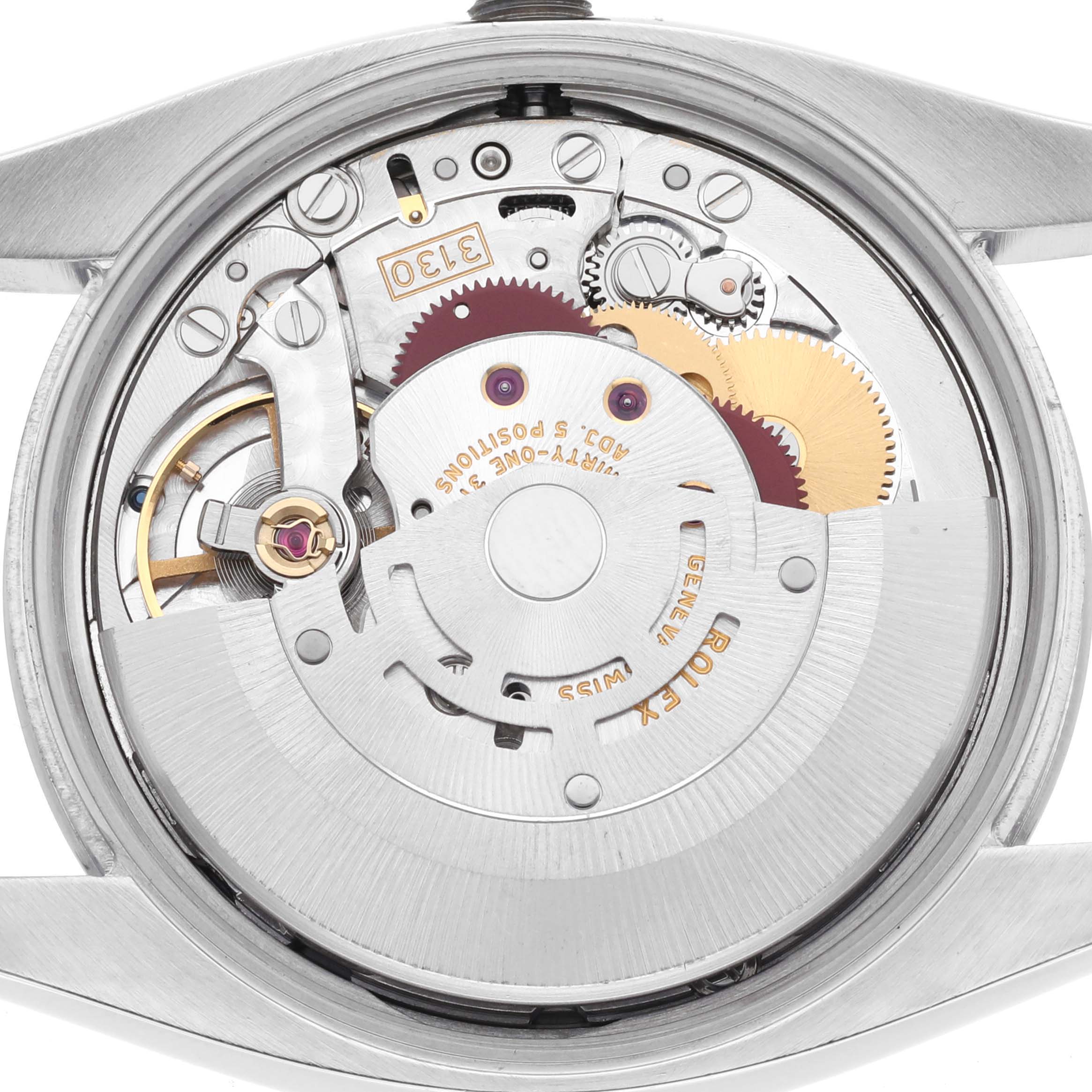 The image shows the movement of a Rolex Air-King 114200 Men's Stainless Steel Silver Dial 114200 Men's Stainless Steel Silver Dial watch from the back, highlighting gears and mechanisms.