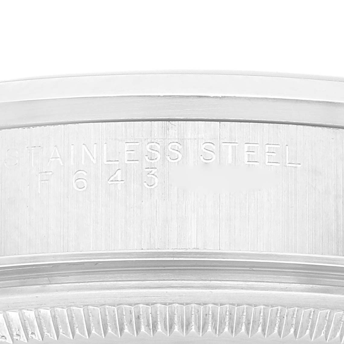 The image shows the side casing engravings on a Rolex Air-King 14000 Men's Stainless Steel Silver Dial 14000 Men's Stainless Steel Silver Dial watch, depicting the "STAINLESS STEEL" text and part of the serial number.