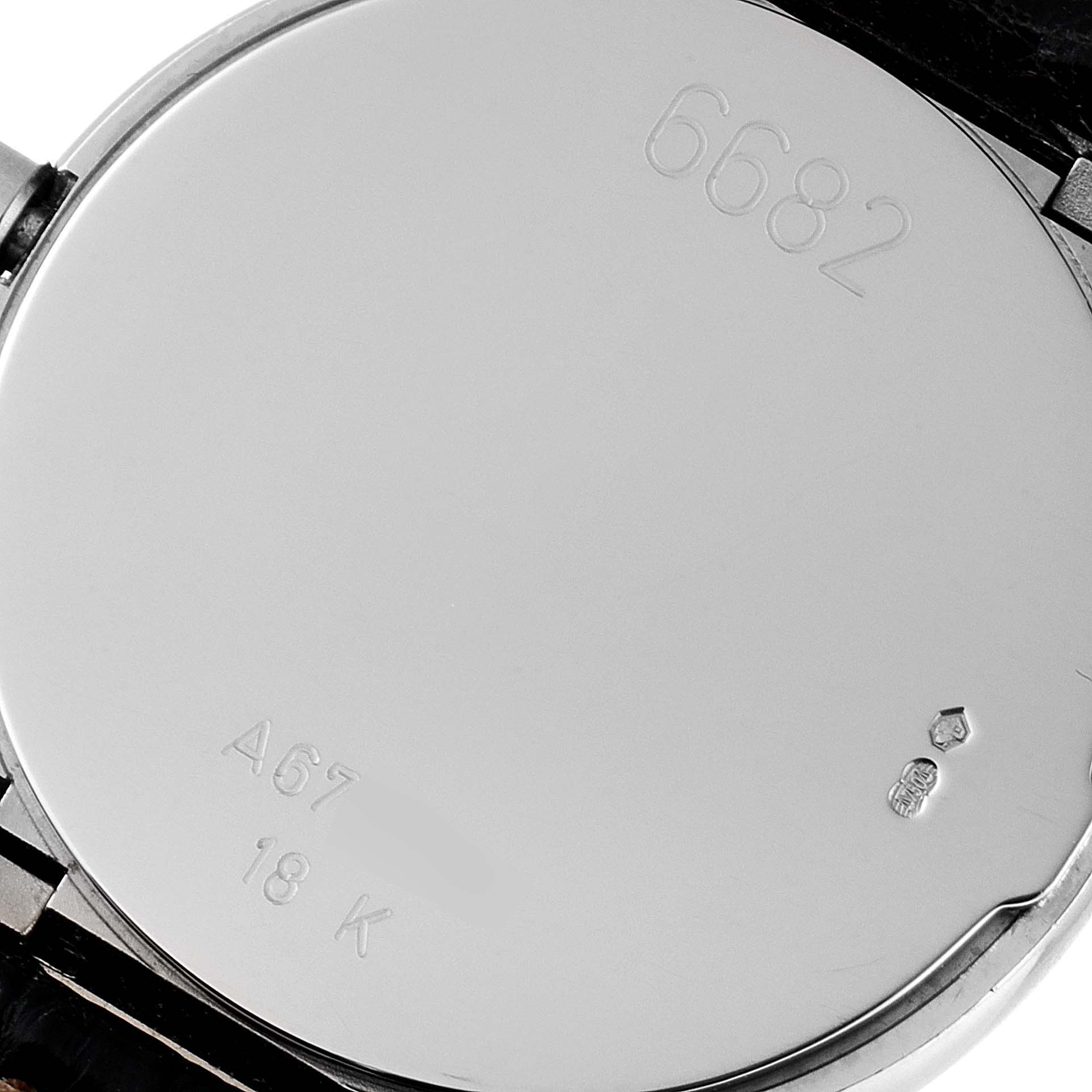 This is the back view of a Rolex Cellini 6682/9 Women's White Gold Silver Dial 6682/9 Women's White Gold Silver Dial watch, showing the caseback with various engravings.