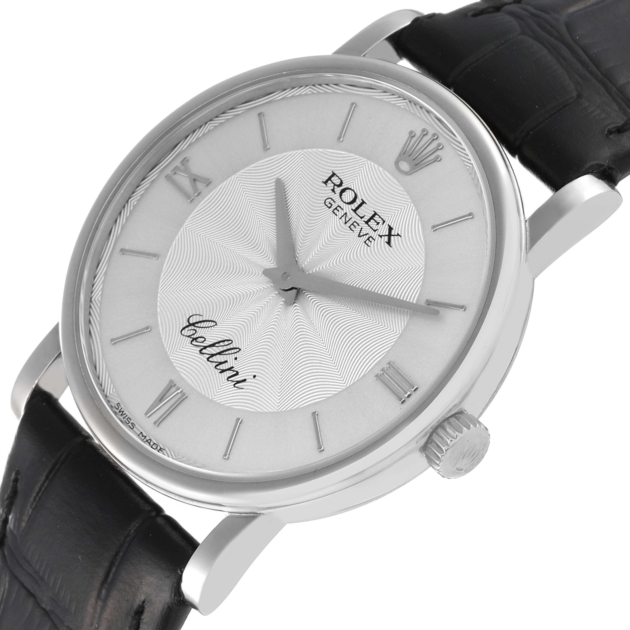 The image shows a Rolex Cellini 5115/9 Men
s White Gold Silver Dial 5115/9 Men
s White Gold Silver Dial watch from an oblique angle, highlighting the dial, crown, and part of the leather strap.