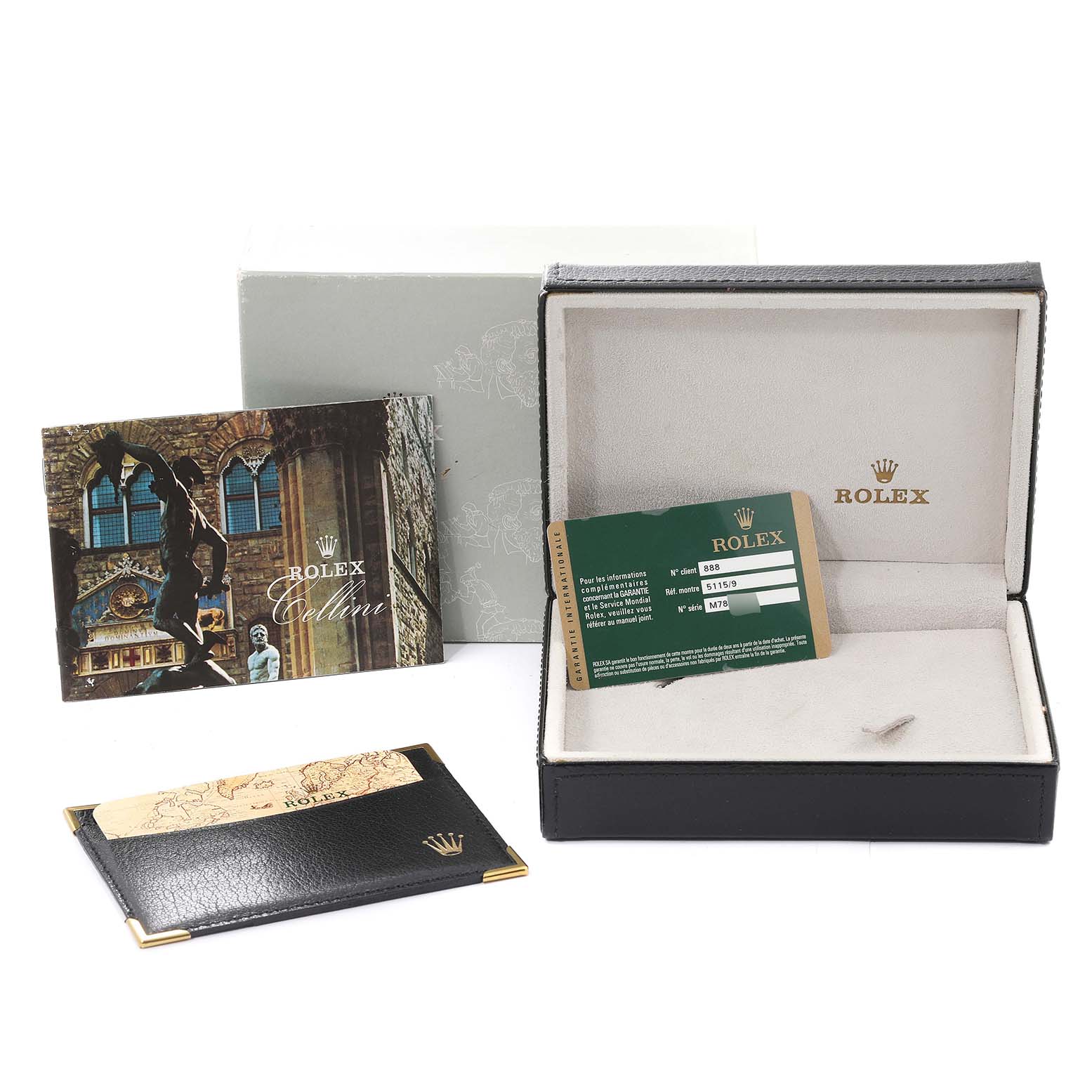 This image shows an open Rolex Cellini 5115/9 Men
s White Gold Silver Dial 5115/9 Men
s White Gold Silver Dial watch box, warranty card, manual, and leather cardholder from a front angle.