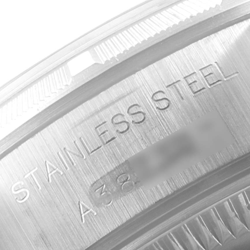 The image shows an engraved stainless steel case side of a Rolex Date 79190 Women's Stainless Steel Black Dial 79190 Women's Stainless Steel Black Dial model watch.