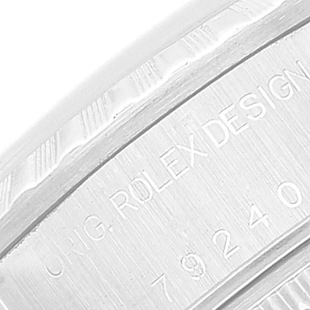 This is a close-up angle of the engraving on the side of a Rolex Date 79240 Women's Stainless Steel Pink Dial 79240 Women's Stainless Steel Pink Dial model watch, showing "ORIG. ROLEX DESIGN."