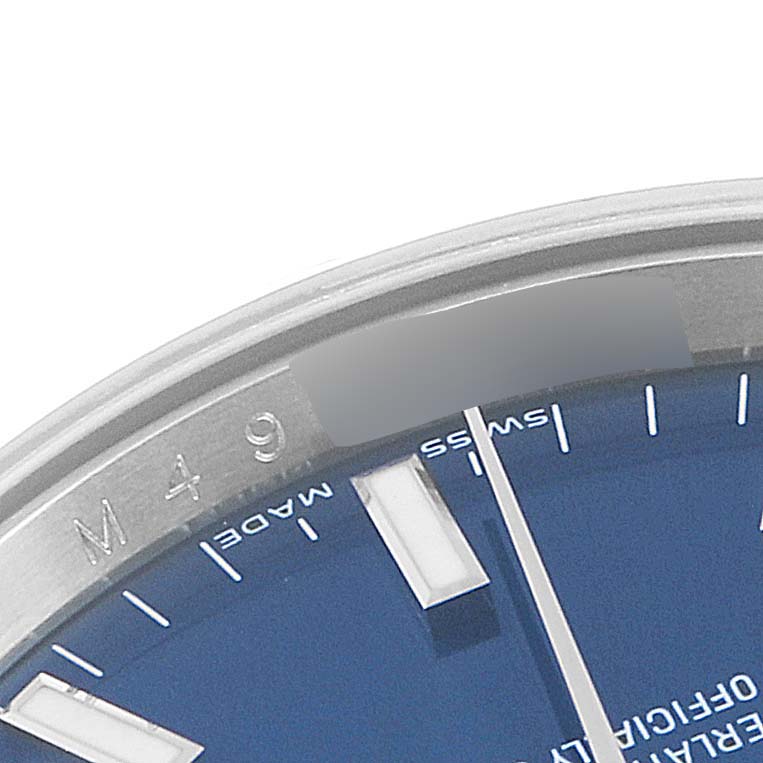This image shows a close-up of the dial, markers, and part of the casing of a Rolex Date 115210 Men's Stainless Steel Blue Dial 115210 Men's Stainless Steel Blue Dial model watch.
