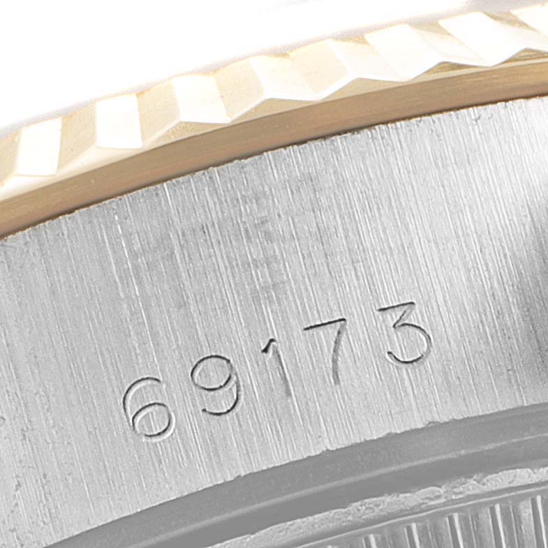 This image shows a close-up of the bezel and case back of a Rolex Datejust 69173 Women
s Steel and Gold (two tone) Champagne Dial 69173 Women
s Steel and Gold (two tone) Champagne Dial watch with the model number 69173.