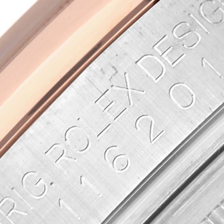 The image shows a close-up of the side of a Rolex Datejust 116201 Men's Steel and Gold (two tone) Pink Dial 116201 Men's Steel and Gold (two tone) Pink Dial, highlighting the engraved lettering.