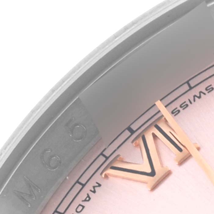 The close-up image shows a partial view of the dial, bezel, and Roman numeral "VI" of a Rolex Datejust 116201 Men's Steel and Gold (two tone) Pink Dial 116201 Men's Steel and Gold (two tone) Pink Dial.