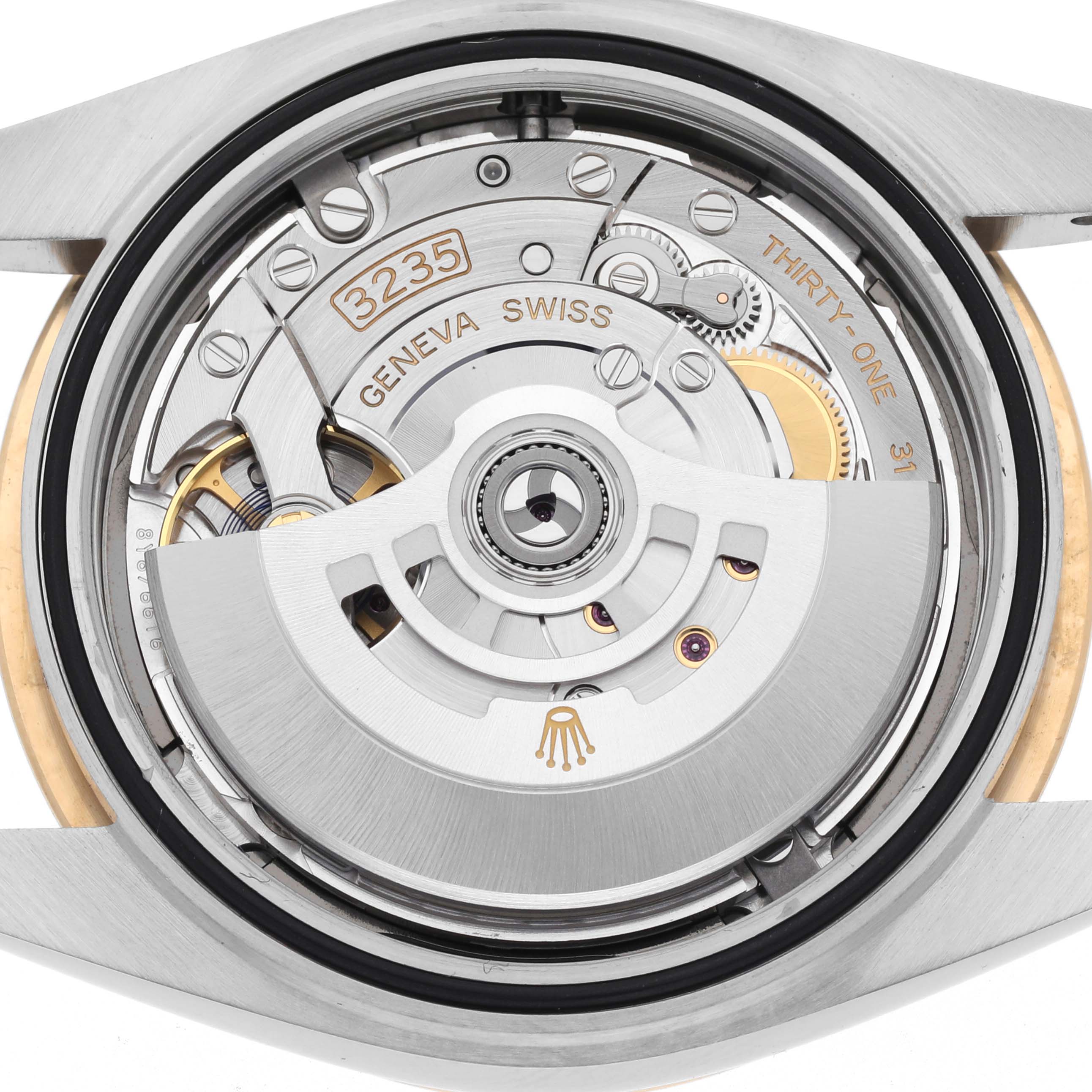 The image shows the movement of the Rolex Datejust 41 126303 Men's Steel and Gold (two tone) Grey Dial 126303 Men's Steel and Gold (two tone) Grey Dial from a top-down angle, highlighting the rotor and intricate mechanics.