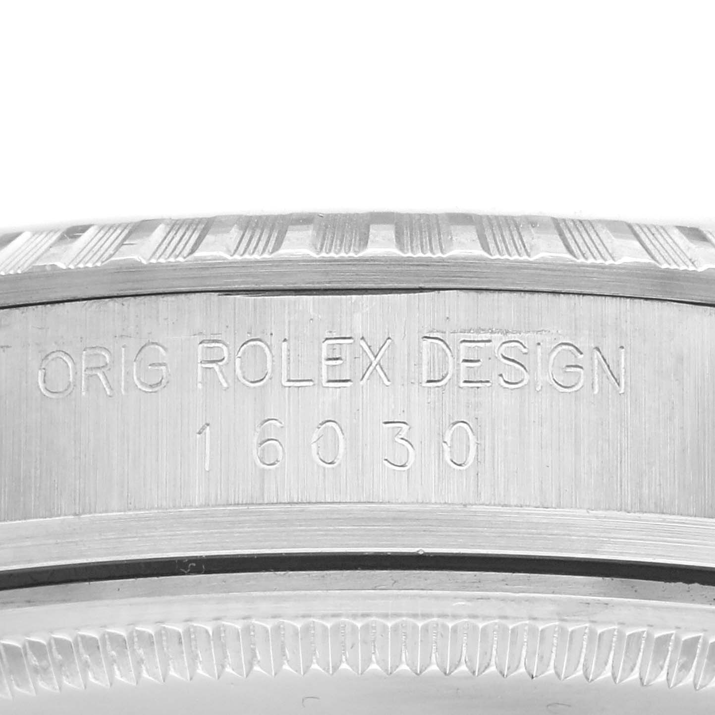 The image shows the side of a Rolex Datejust 16030 Men's Stainless Steel Silver Dial 16030 Men's Stainless Steel Silver Dial case with engraved text and the model number.