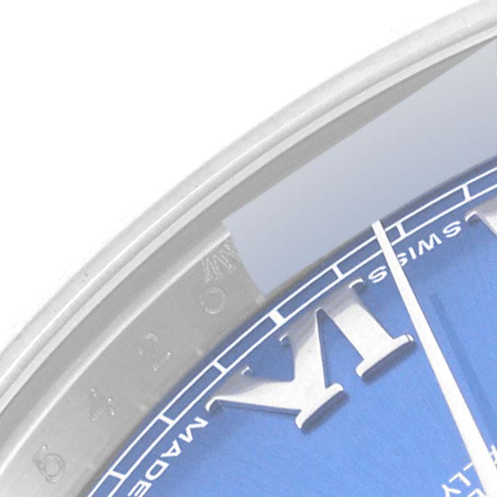 This image shows the edge of the dial and case of a Rolex Datejust 41 116334 Men's Stainless Steel Blue Dial 116334 Men's Stainless Steel Blue Dial watch, featuring Roman numerals and part of the blue dial.
