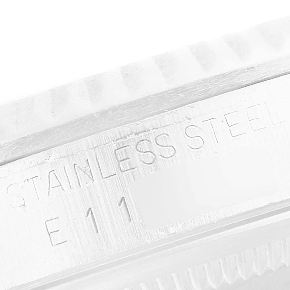 This image shows a close-up of the stainless steel case on a Rolex Datejust 16234 Men's Stainless Steel Silver Dial 16234 Men's Stainless Steel Silver Dial watch, highlighting its engravings.