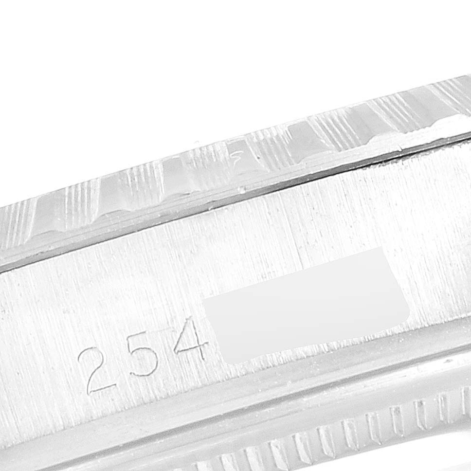 This close-up image of the Rolex Vintage Collection 1603 Men's Stainless Steel Silver Dial 1603 Men's Stainless Steel Silver Dial watch shows the watch's case with serial number engravings.