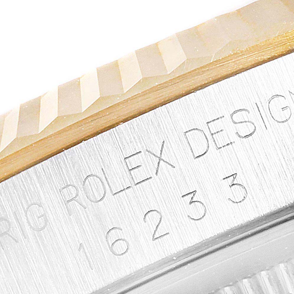 The close-up image shows the fluted bezel and engraving on the case of a Rolex Datejust 16233 Men's Steel and Gold (two tone) Grey Dial 16233 Men's Steel and Gold (two tone) Grey Dial watch.