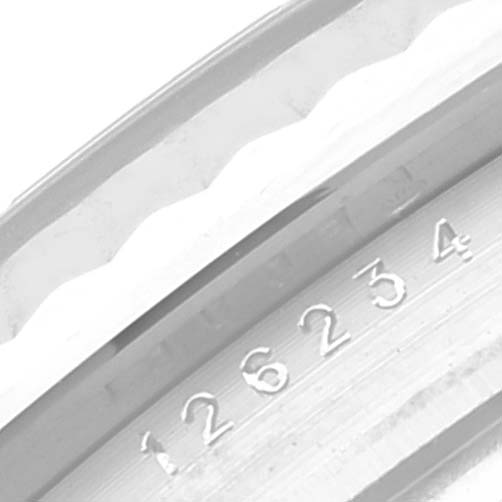 This close-up image shows the case number and part of the bezel of a Rolex Datejust 126234 Men's Stainless Steel Purple Dial 126234 Men's Stainless Steel Purple Dial watch.