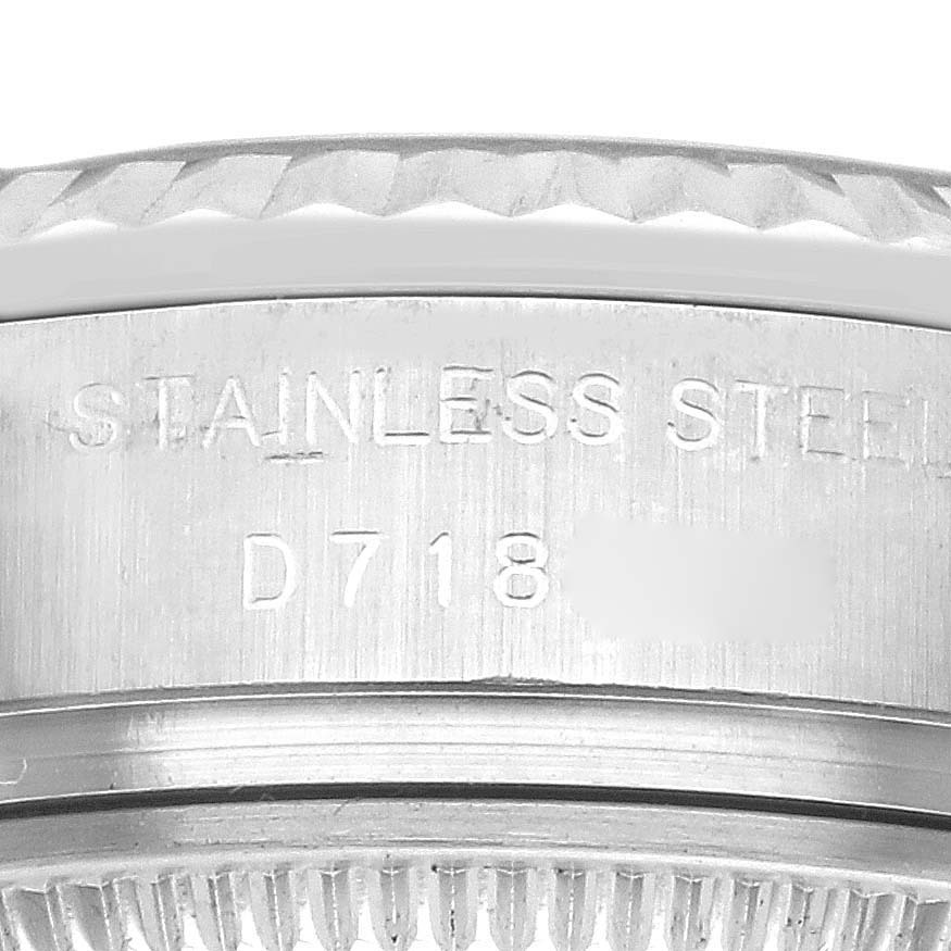 The image shows a close-up of the engraved side of the Rolex Cocktail 179174 Women
s Stainless Steel Silver Dial 179174 Women
s Stainless Steel Silver Dial watch
s stainless steel case, with serial numbers visible.