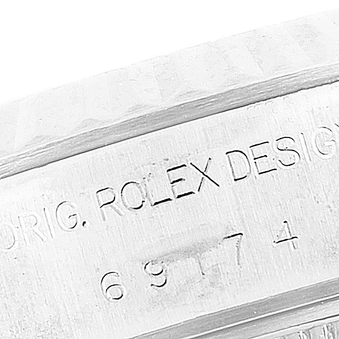 This image shows a close-up of the engraved side of the Rolex Datejust 69174 Women's Stainless Steel Mother of Pearl Dial 69174 Women's Stainless Steel Mother of Pearl Dial watch, displaying the design and model number.