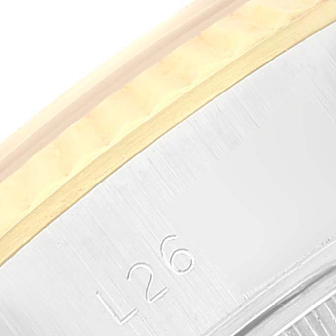 Close-up of the edge of a Rolex Datejust 69173 Women's Steel and Gold (two tone) Champagne Dial 69173 Women's Steel and Gold (two tone) Champagne Dial watch showing the bezel and part of the band with an engraving of "L26".