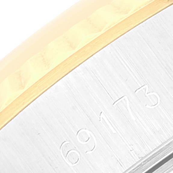 The image shows a close-up angle of the serial number engraving on the metal case of a Rolex Datejust 69173 Women's Steel and Gold (two tone) Champagne Dial 69173 Women's Steel and Gold (two tone) Champagne Dial model watch.