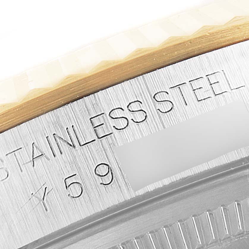 This image shows a close-up angle of the stainless steel case back of a Rolex Datejust 16233 Men's Steel and Gold (two tone) Champagne Dial 16233 Men's Steel and Gold (two tone) Champagne Dial watch, including part of the bezel.