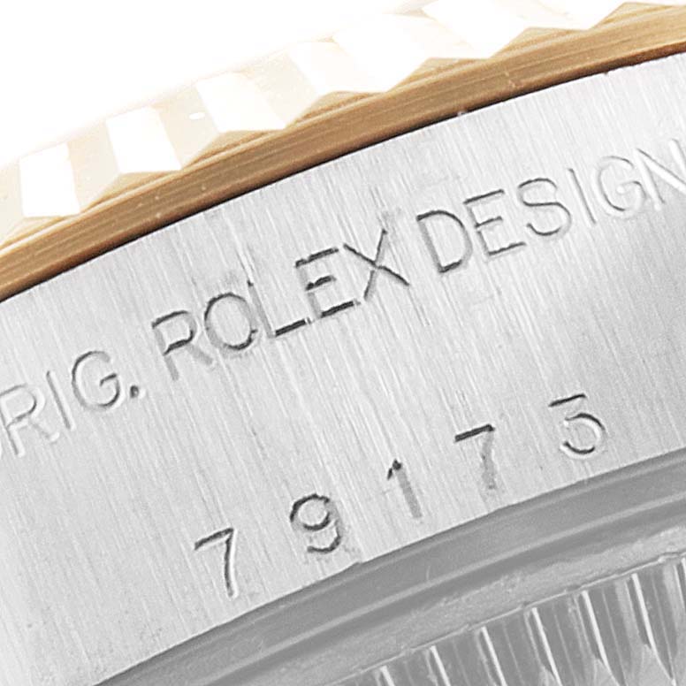 This close-up image shows the engraved model number and part of the fluted bezel of the Rolex Datejust 79173 Women
s Steel and Gold (two tone) Champagne Dial 79173 Women
s Steel and Gold (two tone) Champagne Dial watch.