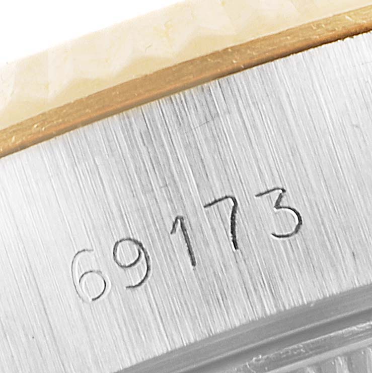 The image shows a close-up of the serial number engraving on the side of a Rolex Datejust 69173 Women's Steel and Gold (two tone) Champagne Dial 69173 Women's Steel and Gold (two tone) Champagne Dial watch case.