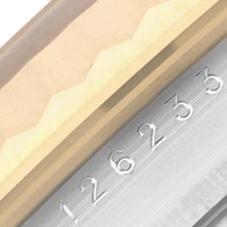 The image shows a close-up of the Rolex Datejust 126233 Men's Steel and Gold (two tone) Champagne Dial 126233 Men's Steel and Gold (two tone) Champagne Dial bezel and part of the rehaut with engraved serial numbers.