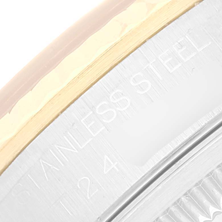 This close-up image shows the edge and metallic surface detail of a Rolex Datejust 16233 Men's Steel and Gold (two tone) White Dial 16233 Men's Steel and Gold (two tone) White Dial watch, highlighting the "STAINLESS STEEL" inscription.