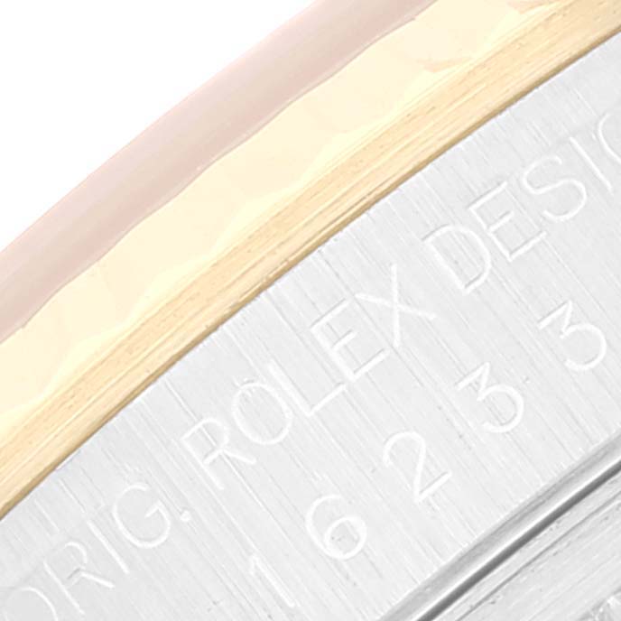 This close-up image shows the side view of the case and bezel of a Rolex Datejust 16233 Men's Steel and Gold (two tone) White Dial 16233 Men's Steel and Gold (two tone) White Dial watch, with engraved text visible.